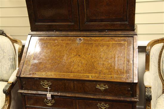 A Queen Anne walnut and featherbanded bureau cabinet, W.3ft 5in.